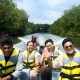 Exploring the lush green Bintan mangrove ecosystem on a traditional boat.